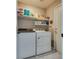 Functional laundry room featuring a washer, dryer, storage shelves, and efficient layout at 1048 Menands Ave, Las Vegas, NV 89123