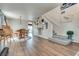 Bright open-concept living space features hardwood floors, a dining area, and a staircase leading to the upper level at 1048 Menands Ave, Las Vegas, NV 89123
