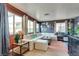 Spacious living area with a large sectional sofa, hardwood floors, and ample natural light from multiple windows at 1048 Menands Ave, Las Vegas, NV 89123