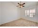 Bright and airy bedroom with neutral carpeting, a ceiling fan, and a view at 10550 W Alexander Rd # 2220, Las Vegas, NV 89129
