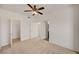A cozy bedroom featuring a ceiling fan, neutral carpet, and an adjacent walk-in closet at 10550 W Alexander Rd # 2220, Las Vegas, NV 89129