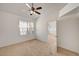 Bright bedroom with neutral carpet, ceiling fan, and an attached room at 10550 W Alexander Rd # 2220, Las Vegas, NV 89129