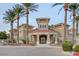 Welcoming clubhouse entrance featuring palm trees and beautiful facade at 10550 W Alexander Rd # 2220, Las Vegas, NV 89129