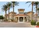 Welcoming clubhouse entrance featuring palm trees and beautiful facade at 10550 W Alexander Rd # 2220, Las Vegas, NV 89129