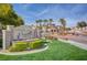 Elegant Chateau Versailles community entrance featuring lush landscaping and inviting architecture with palm trees against a blue sky at 10550 W Alexander Rd # 2220, Las Vegas, NV 89129