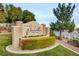 Elegant Chateau Versailles community entrance featuring lush landscaping and inviting architecture with trees and a blue sky at 10550 W Alexander Rd # 2220, Las Vegas, NV 89129