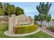 Elegant Chateau Versailles community entrance featuring lush landscaping and inviting architecture with trees and a blue sky at 10550 W Alexander Rd # 2220, Las Vegas, NV 89129