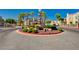 View of entrance to Chateau Versailles community featuring lush landscaping at 10550 W Alexander Rd # 2220, Las Vegas, NV 89129