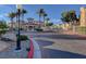 Exterior entrance to community with gated access, lush landscaping, and well-maintained sidewalks at 10550 W Alexander Rd # 2220, Las Vegas, NV 89129