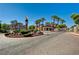 Inviting community entrance with circular drive, landscaping, and elegant monument at 10550 W Alexander Rd # 2220, Las Vegas, NV 89129