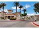 Gated entrance with palm trees and desert landscaping leading to the community at 10550 W Alexander Rd # 2220, Las Vegas, NV 89129