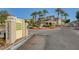 View of entrance to Chateau Versailles community featuring lush landscaping and address at 10550 W Alexander Rd # 2220, Las Vegas, NV 89129