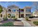Charming townhome with stucco facade, arched entry, and professionally maintained landscaping at 10550 W Alexander Rd # 2220, Las Vegas, NV 89129