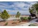 Charming exterior view showcasing landscaped yard and community perimeter views with trees, and plants at 10550 W Alexander Rd # 2220, Las Vegas, NV 89129