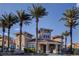 Exterior view of community center with lush landscaping and palm trees at 10550 W Alexander Rd # 2220, Las Vegas, NV 89129