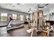 Well-equipped gym with cardio and weight machines, mirrors, and bright natural light at 10550 W Alexander Rd # 2220, Las Vegas, NV 89129