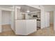 Open kitchen view showcasing tan counters, ample cabinets and easy access to adjacent rooms at 10550 W Alexander Rd # 2220, Las Vegas, NV 89129
