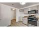 Efficient kitchen layout featuring stainless steel appliances and adjacent laundry area at 10550 W Alexander Rd # 2220, Las Vegas, NV 89129