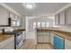 Bright kitchen features stainless steel appliances, wood-look floors, and breakfast bar at 10550 W Alexander Rd # 2220, Las Vegas, NV 89129
