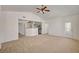 Spacious living room showcasing vaulted ceilings, neutral carpet, and seamless flow to the kitchen at 10550 W Alexander Rd # 2220, Las Vegas, NV 89129