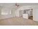 Open concept living room leading to the kitchen with vaulted ceilings and neutral carpeting at 10550 W Alexander Rd # 2220, Las Vegas, NV 89129
