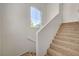 Well-lit stairway with neutral carpeting and a large window at 10550 W Alexander Rd # 2220, Las Vegas, NV 89129