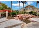 Beautiful water feature with rocks and palm trees near the community grilling area at 10550 W Alexander Rd # 2220, Las Vegas, NV 89129