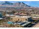 An aerial view features a pool, commercial buildings, and a parking garage at 11239 Cactus Tower Ave # 102, Las Vegas, NV 89135