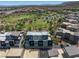 An aerial view of a community showcasing modern townhomes, lush green spaces, a playground and scenic mountain views at 11239 Cactus Tower Ave # 102, Las Vegas, NV 89135