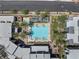 Overhead view of a community pool with light blue water, palm trees, lounge chairs, and modern buildings at 11239 Cactus Tower Ave # 102, Las Vegas, NV 89135