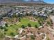 An aerial view of a residential neighborhood showcasing a greenbelt and walking trails at 11239 Cactus Tower Ave # 102, Las Vegas, NV 89135