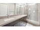 Bright bathroom featuring a double sink vanity and a glass-enclosed shower with tiled walls at 11239 Cactus Tower Ave # 102, Las Vegas, NV 89135