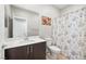 Bathroom featuring a vanity with a dark brown cabinet, a white sink, and a shower with a floral curtain at 11239 Cactus Tower Ave # 102, Las Vegas, NV 89135
