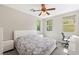 Inviting bedroom featuring a ceiling fan, neutral décor, and bright windows, creating a serene and comfortable living space at 11239 Cactus Tower Ave # 102, Las Vegas, NV 89135