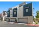 Modern townhome featuring clean lines, gray tones, a visible address, and an attached garage at 11239 Cactus Tower Ave # 102, Las Vegas, NV 89135