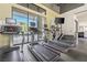 Modern fitness center featuring treadmills, tv screens, and large windows with views of the outdoor area at 11239 Cactus Tower Ave # 102, Las Vegas, NV 89135