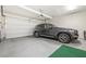 Clean garage with a parked SUV, a door, and epoxy flooring, showcasing functional vehicle storage space at 11239 Cactus Tower Ave # 102, Las Vegas, NV 89135