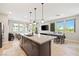 Contemporary kitchen with an island, pendant lighting, stainless steel appliances, and an open floorplan at 11239 Cactus Tower Ave # 102, Las Vegas, NV 89135