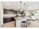 Stylish kitchen featuring stainless steel appliances, island with seating, and dark wood cabinets at 11239 Cactus Tower Ave # 102, Las Vegas, NV 89135