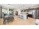 Bright kitchen with stainless steel appliances, large island, and seamless flow to the dining area at 11239 Cactus Tower Ave # 102, Las Vegas, NV 89135
