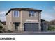 Two-story home featuring a three car garage and desert landscaping at 1198 Dre Harbor Pl. Ln # 86, North Las Vegas, NV 89084