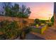Landscaped backyard with raised garden beds, mature trees, and a stone patio, offering a peaceful outdoor escape at 12276 Caminita Pl, Las Vegas, NV 89138