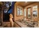 Backyard patio featuring outdoor seating, a decorative statue, and an entrance to the home at 12276 Caminita Pl, Las Vegas, NV 89138