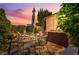 Inviting backyard featuring a patio dining set, shade umbrella, and landscaped garden, perfect for outdoor gatherings at 12276 Caminita Pl, Las Vegas, NV 89138