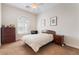 Cozy bedroom with ceiling fan, ample natural light, and neutral decor, creating a peaceful and inviting space at 12276 Caminita Pl, Las Vegas, NV 89138