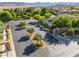 Gated community entrance featuring manicured landscaping, decorative signage, and tree-lined streets at 12276 Caminita Pl, Las Vegas, NV 89138