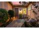 Inviting courtyard featuring paved flooring, lush landscaping, and a cozy seating area perfect for enjoying the outdoors at 12276 Caminita Pl, Las Vegas, NV 89138
