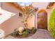 Charming courtyard featuring a lovely fountain, greenery, and a secure gate at 12276 Caminita Pl, Las Vegas, NV 89138