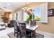 Bright dining area with a wooden table set, a large window, and a view of the outdoor space at 12276 Caminita Pl, Las Vegas, NV 89138