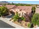 Well-maintained home with desert landscaping, tile roof, and a two-car garage on a corner lot at 12276 Caminita Pl, Las Vegas, NV 89138